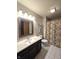 Inviting bathroom with modern fixtures, tiled floor, and a shower and tub combo with curtain at 11506 Hidden Bay, Indianapolis, IN 46236