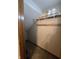 Ample storage with a sloped ceiling and available shelving in this walk-in closet at 11506 Hidden Bay, Indianapolis, IN 46236