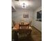 View of dining area with wood-look floors next to a kitchen pass through at 11506 Hidden Bay, Indianapolis, IN 46236