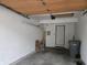 Attached garage with door to outside, white walls, and concrete floor at 11506 Hidden Bay, Indianapolis, IN 46236