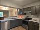 View of the kitchen pass through to dining area, showcasing stainless steel appliances and marbled counter tops at 11506 Hidden Bay, Indianapolis, IN 46236