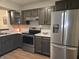 A close up view of stainless appliances, dark cabinets, and marbled countertop at 11506 Hidden Bay, Indianapolis, IN 46236