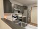 Another view of the kitchen stainless steel appliances, marbled counter tops, and dark cabinets at 11506 Hidden Bay, Indianapolis, IN 46236