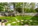 Spacious backyard with a privacy fence, manicured lawn, and stone pathway at 1240 E 56Th St, Indianapolis, IN 46220