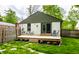 Backyard deck provides outdoor space with a table and chairs, and a well-manicured lawn at 1240 E 56Th St, Indianapolis, IN 46220