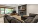 Stylish basement with a comfy gray couch and modern fireplace with wood mantel at 1240 E 56Th St, Indianapolis, IN 46220