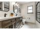 Modern bathroom featuring a double vanity, black fixtures, and stylish tile flooring at 1240 E 56Th St, Indianapolis, IN 46220