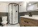 Stylish bathroom with a black-framed shower and vanity, combining modern design with functional space at 1240 E 56Th St, Indianapolis, IN 46220