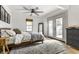 Bright bedroom with a cozy bed, ceiling fan, french doors, and stylish decor, creating a relaxing space at 1240 E 56Th St, Indianapolis, IN 46220