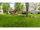 Landscaped front yard with green lawn and a charming house featuring a covered porch at 1240 E 56Th St, Indianapolis, IN 46220