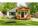 Charming home with a gabled facade, a wooden porch, and a well-manicured lawn at 1240 E 56Th St, Indianapolis, IN 46220
