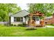 Charming home featuring a manicured lawn, decorative stone, and a covered front porch at 1240 E 56Th St, Indianapolis, IN 46220