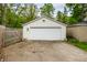 Detached one car garage with a white garage door and concrete parking pad at 1240 E 56Th St, Indianapolis, IN 46220