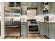Well-equipped kitchen with stainless steel appliances, gray cabinets, and a bright, functional layout at 1240 E 56Th St, Indianapolis, IN 46220