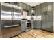 Modern kitchen featuring stainless steel appliances, ample gray cabinetry, and stylish tile backsplash at 1240 E 56Th St, Indianapolis, IN 46220