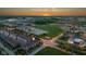 Aerial view of the townhome complex showcasing the community, green space, and sunset at 13094 Overview Dr # 5D, Fishers, IN 46037