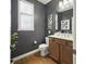 Stylish half bathroom with dark gray walls, modern vanity, and hardwood floors at 13094 Overview Dr # 5D, Fishers, IN 46037