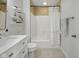 A clean bathroom featuring a shower-tub combination with tiled surround and modern fixtures at 13094 Overview Dr # 5D, Fishers, IN 46037