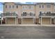 Townhome exterior featuring garages and decks, offering convenient parking and outdoor space at 13094 Overview Dr # 5D, Fishers, IN 46037