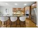 Spacious kitchen featuring a large island with seating, wooden cabinets, and hardwood floors at 13094 Overview Dr # 5D, Fishers, IN 46037