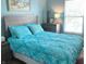 Well-lit bedroom features a bed with patterned blue comforter and matching shams, plus bedside tables at 14058 Southwood Cir, Fishers, IN 46037