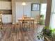 Cozy dining area with wood-look floors, white cabinets, and a natural light-filled space perfect for meals at 14058 Southwood Cir, Fishers, IN 46037