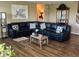 Spacious living room with hardwood floors, a large sectional sofa, and contemporary decor for comfortable living at 14058 Southwood Cir, Fishers, IN 46037