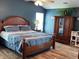 Beautiful bedroom with blue walls, hardwood floors, a large bed, and a wardrobe offering a tranquil retreat at 14058 Southwood Cir, Fishers, IN 46037