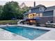 Beautiful backyard with a pool, patio furniture, and landscaped areas at 1490 N County Road 50 E, Danville, IN 46122
