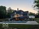Stunning backyard featuring a refreshing pool, outdoor seating, and manicured landscaping at 1490 N County Road 50 E, Danville, IN 46122