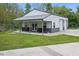 New white barn with a full porch, outdoor seating, metal roof, and two garage doors at 1490 N County Road 50 E, Danville, IN 46122