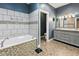 The primary bath features a soaking tub, blue walls, and a separate room for the toilet at 1490 N County Road 50 E, Danville, IN 46122