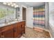 Bathroom featuring an ornate vanity, a shower with a colorful curtain, and neutral walls at 1490 N County Road 50 E, Danville, IN 46122