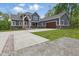 Beautiful two-story home featuring a large driveway, two-car garage, and welcoming front porch at 1490 N County Road 50 E, Danville, IN 46122