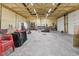 Large, unfinished garage with multiple bays, workbenches, and plenty of space for storage at 1490 N County Road 50 E, Danville, IN 46122