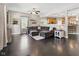 Inviting living room with a large gray sectional sofa, dark hardwood floors, and ample natural light from the windows at 1490 N County Road 50 E, Danville, IN 46122