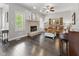 Cozy living room with a stone fireplace, comfortable seating, hardwood floors and a view to the outdoors at 1490 N County Road 50 E, Danville, IN 46122