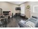 Spacious living room features wood floors, a gray sofa, and a mounted television at 1490 N County Road 50 E, Danville, IN 46122