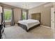 Bright main bedroom features carpet, two windows, and neutral décor; a peaceful haven for rest and relaxation at 1490 N County Road 50 E, Danville, IN 46122