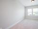 Bare bedroom with neutral walls and carpet, with a window letting in natural light at 15792 Wiseman Dr, Fishers, IN 46040