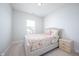 Cozy bedroom featuring a floral patterned bed, neutral walls, and a light colored carpet at 15792 Wiseman Dr, Fishers, IN 46040