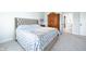 Comfortable bedroom with a tufted headboard, armoire and neutral color scheme at 15792 Wiseman Dr, Fishers, IN 46040