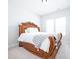 Elegant bedroom with a carved wooden bed and plush carpet, featuring large windows and lots of light at 15792 Wiseman Dr, Fishers, IN 46040