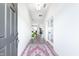 Inviting entryway with hardwood floors, a colorful rug and lots of natural light at 15792 Wiseman Dr, Fishers, IN 46040