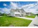 Beautiful two-story home with manicured lawn, gray accents, and attached two car garage at 15792 Wiseman Dr, Fishers, IN 46040