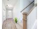 Well-lit hallway with a decorative rug leading to the front door and stairs to the side at 15792 Wiseman Dr, Fishers, IN 46040