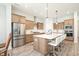 Spacious kitchen with stainless steel appliances, large island, and modern light fixtures at 15792 Wiseman Dr, Fishers, IN 46040