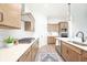 Modern kitchen with stainless steel appliances, wood cabinets, white backsplash, and white countertops at 15792 Wiseman Dr, Fishers, IN 46040