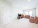 A cozy living room featuring neutral walls, recessed lighting, and comfortable leather sofas at 15792 Wiseman Dr, Fishers, IN 46040