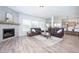 Comfortable living room featuring a fireplace, plush leather seating, and open floorplan at 15792 Wiseman Dr, Fishers, IN 46040